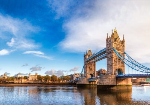 Panoramic London skyline with iconic symbol, the Tower Bridge and Her Majesty's Royal Palace and Fortress, known as the Tower of London as viewed from South Bank of the River Thames in the morning light