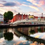 Dublin, Ireland. Night view of famous illuminated Ha Penny Bridge in Dublin, Ireland at sunset